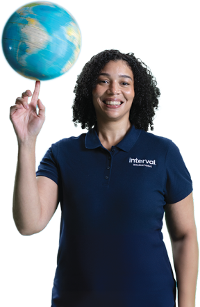 woman in Interval International shirt spinning a globe on her finger like a basketball